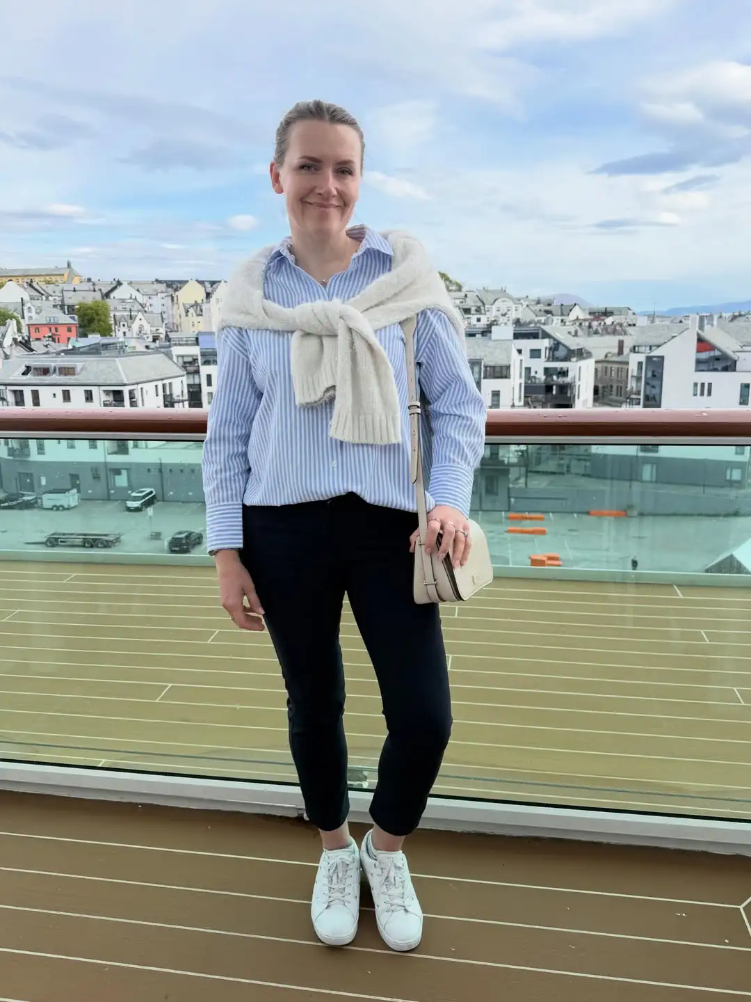 15 Chic Outfits for Women Over 40 You Can Copy This Week 7 Striped Shirt With a Sweater Tied Over the Shoulders