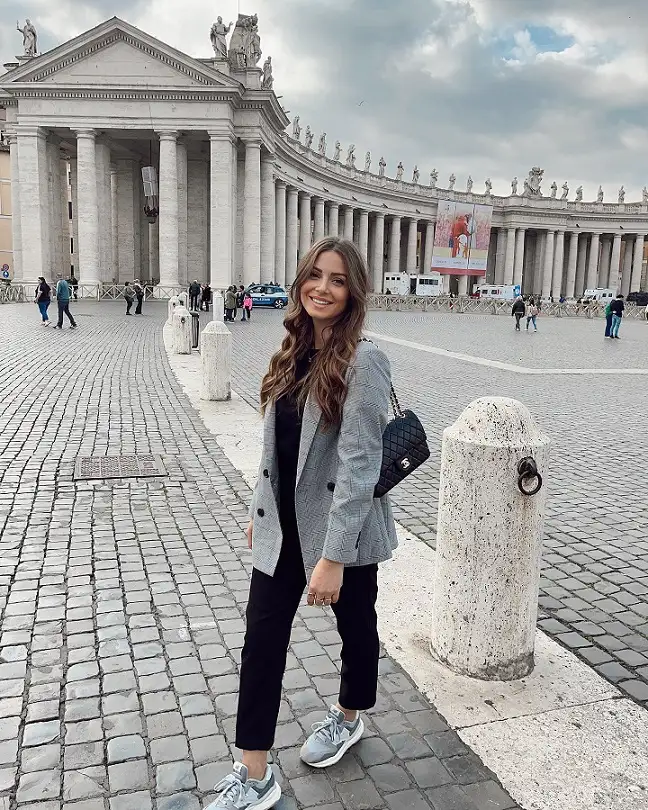 17 Italy Vacation Outfits for Women Over 40 That Look Effortlessly Chic 10 Gray Plaid Blazer with Black Trousers and Sneakers