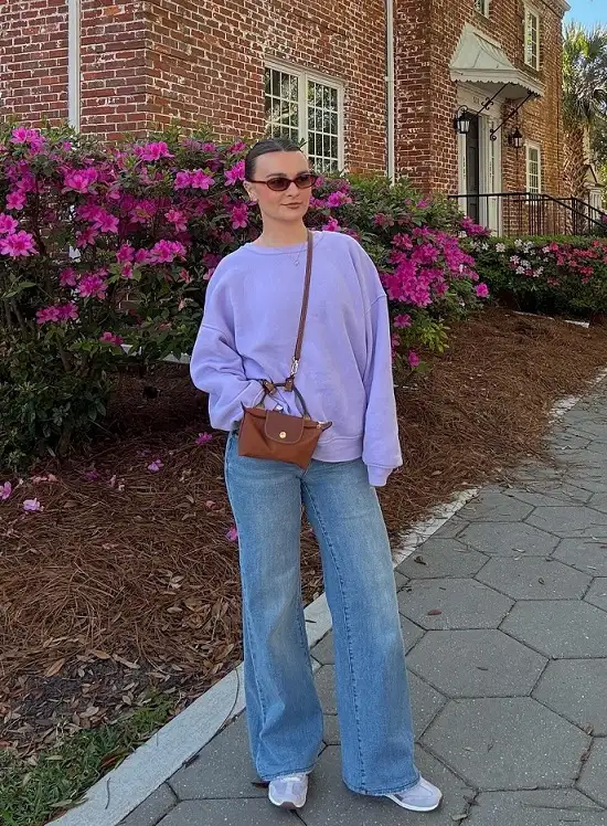 18 Spring Work Outfits for Women Over 40 That Feel Fresh, Not Fussy 13 Lilac Sweatshirt and Wide Leg Jeans for Casual Friday