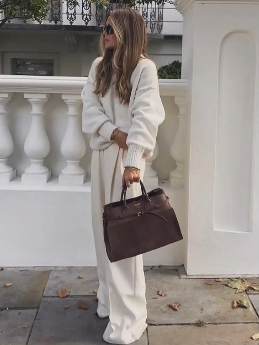 20 Quiet Luxury Outfits for Women Over 40 (Old Money Style, Real-Life Ready) 21 Cream Knit and Wide Trousers With a Chocolate Suede Bag