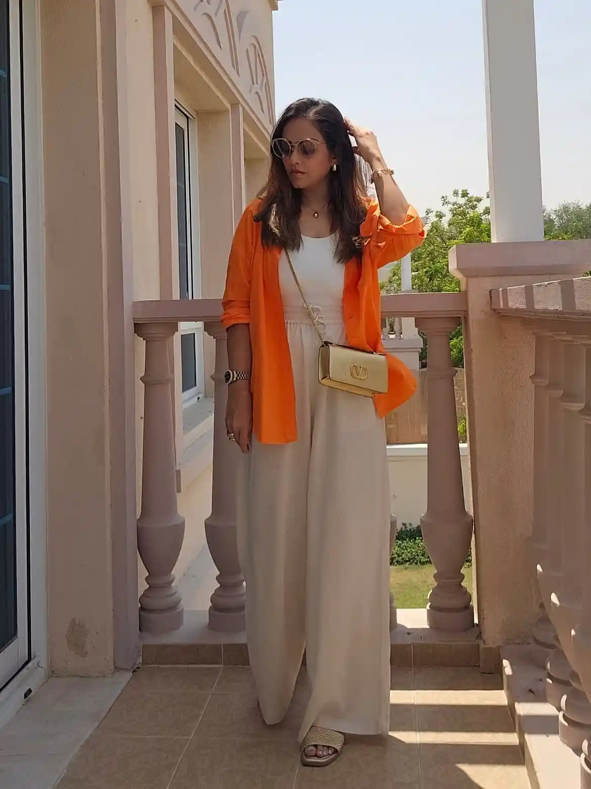 15 Linen Outfits for Women Over 40 That Feel Easy and Look Polished 8 7. Bright Orange Shirt With Beige Wide Leg Pants