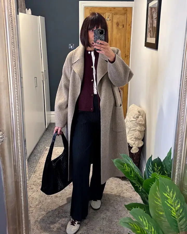 20 Work Outfits for Women Over 40 That Look Effortlessly Polished 14 Oatmeal Wool Coat with a Burgundy Cardigan