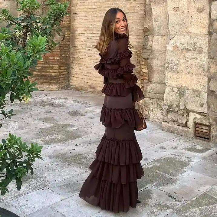 15 Winter Wedding Guest Outfits Over 40 That Handle the Cold 4 Chocolate Brown Tiered Ruffle Maxi