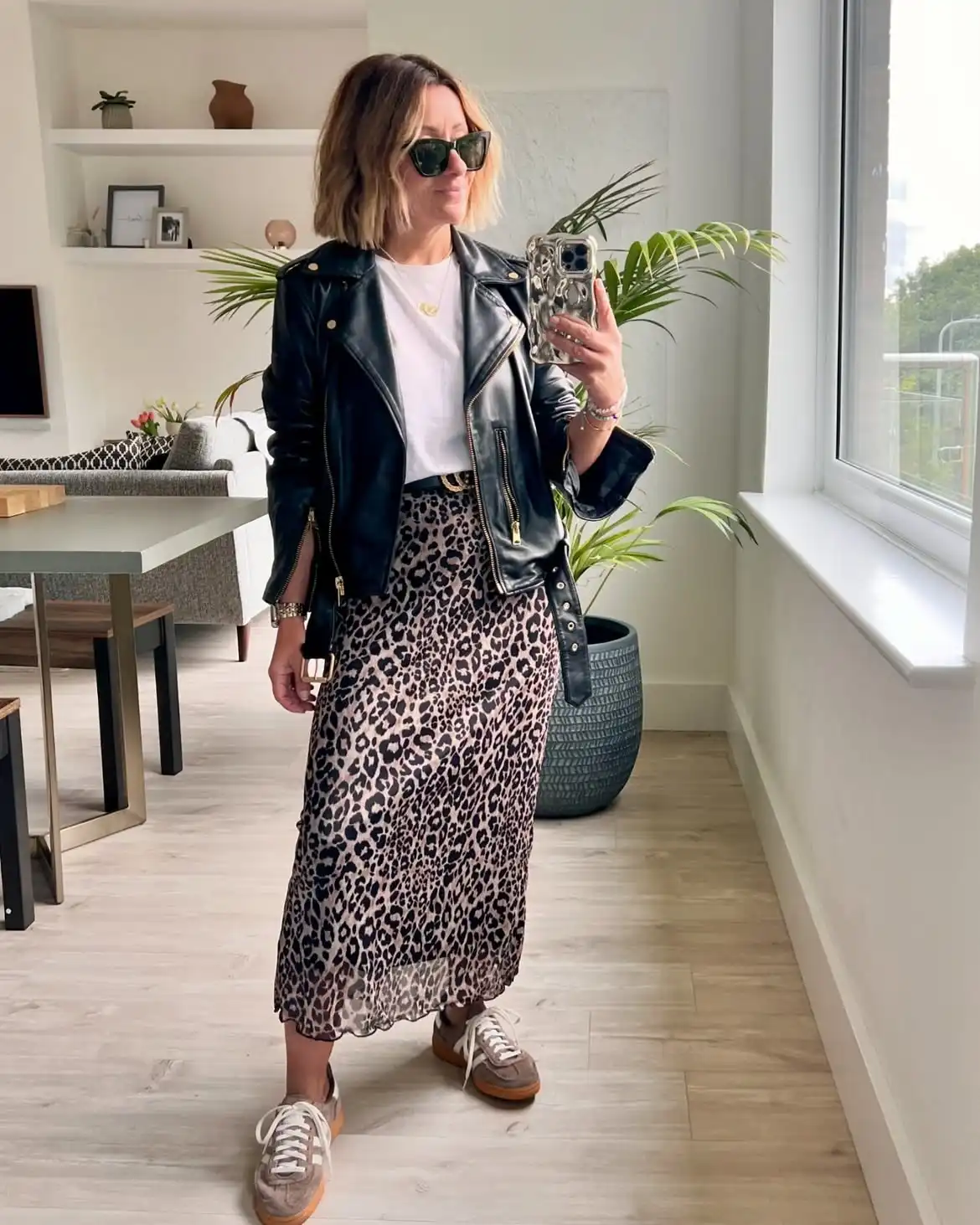 15 Leather Jacket Outfits for Women Over 40 That Actually Work 2 1. Leather Jacket and Leopard Midi Skirt