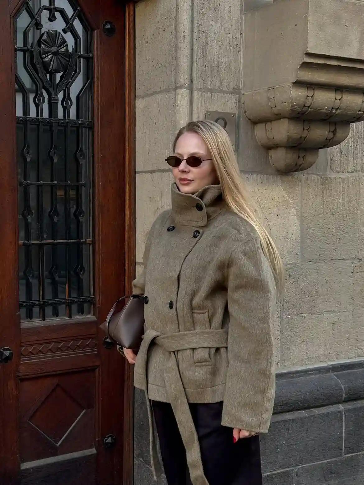 19 Winter Vacation Outfits Over 40 (Warm Getaways) 8 7. Belted Olive Jacket for Cool City Evenings