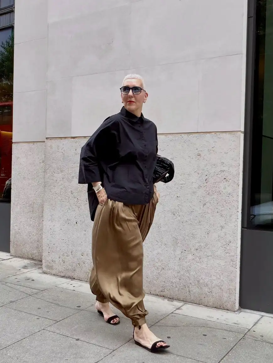 20 Work Outfits for Women Over 40 That Look Effortlessly Polished 3 Oversized Black Shirt with Bronze Satin Trousers