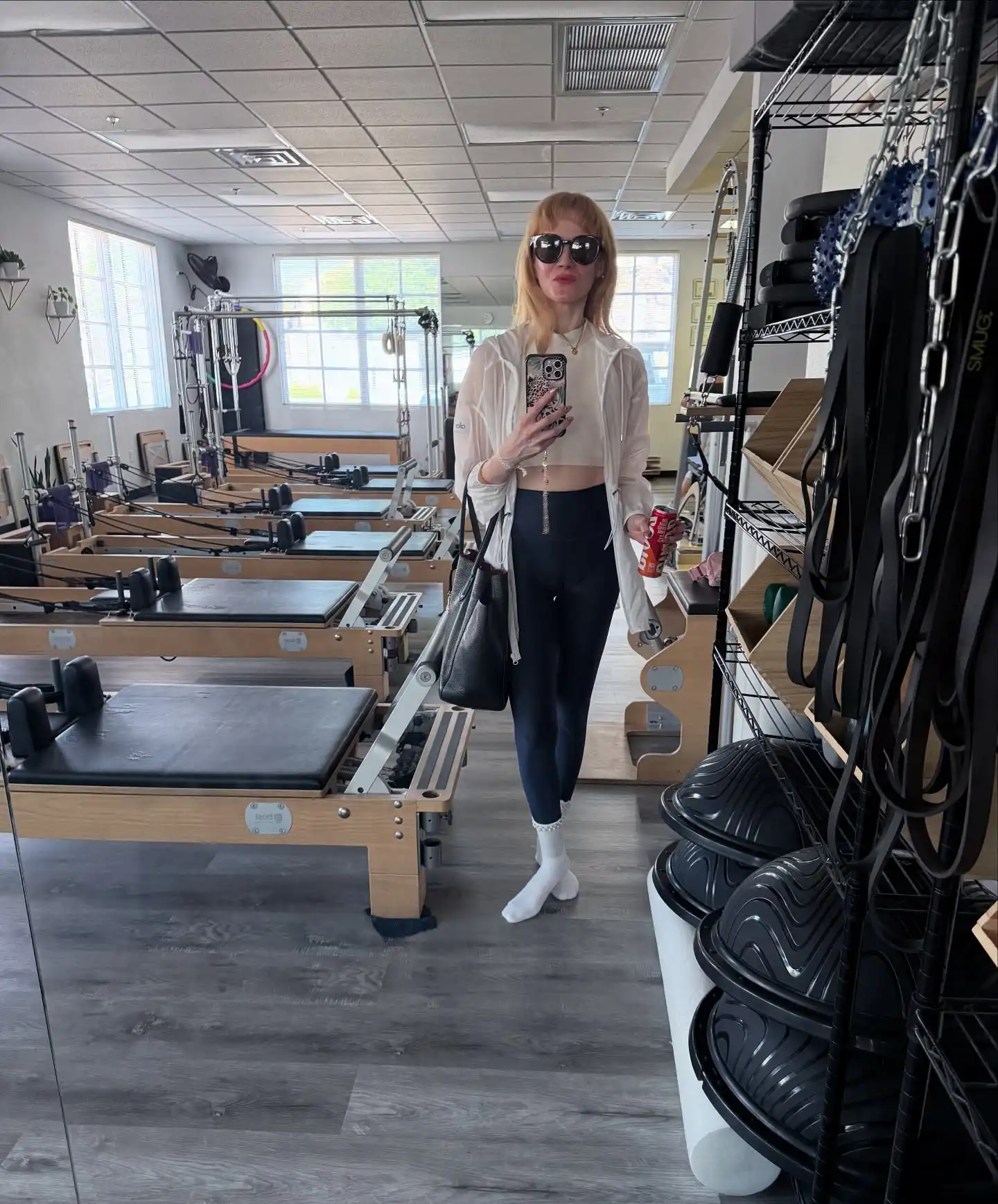 Pilates Outfits for Women Over 40: 10 Looks That Stay Put 4 3. Layered Hoodie with Cropped Top and Black Leggings