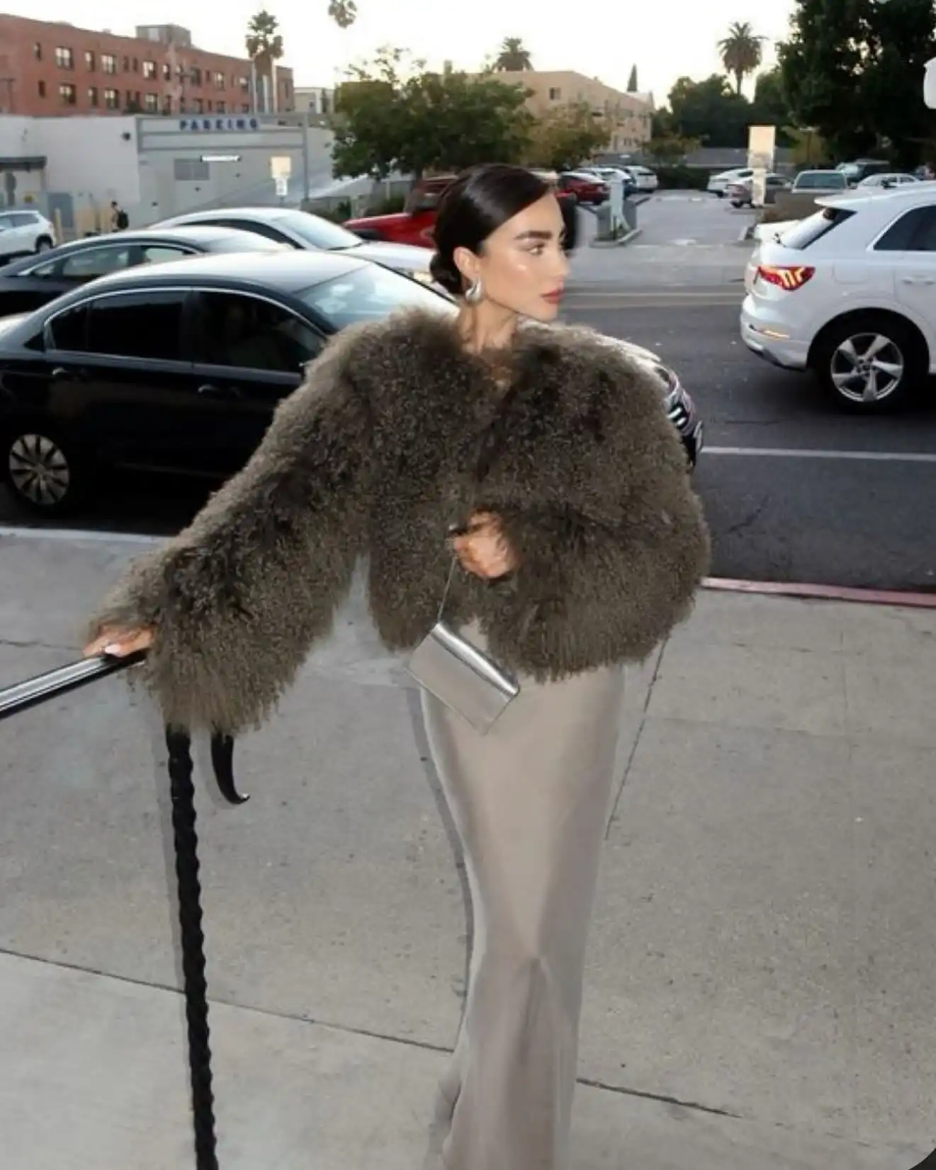 15 Winter Wedding Guest Outfits Over 40 That Handle the Cold 11 Champagne Satin Slip Dress Under a Cropped Fur Jacket