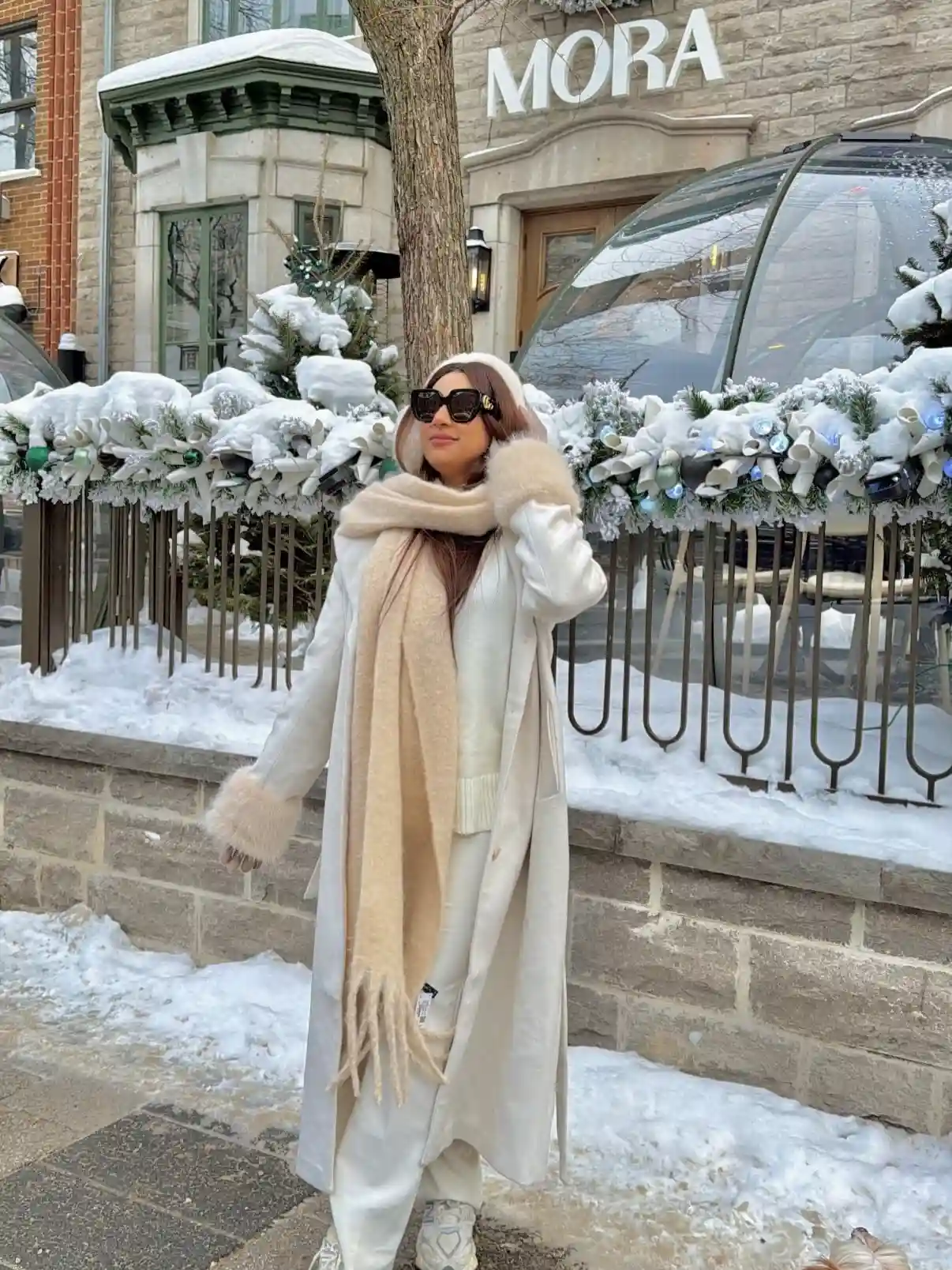 19 Winter Vacation Outfits Over 40 (Warm Getaways) 7 6. Long White Coat With a Chunky Beige Scarf
