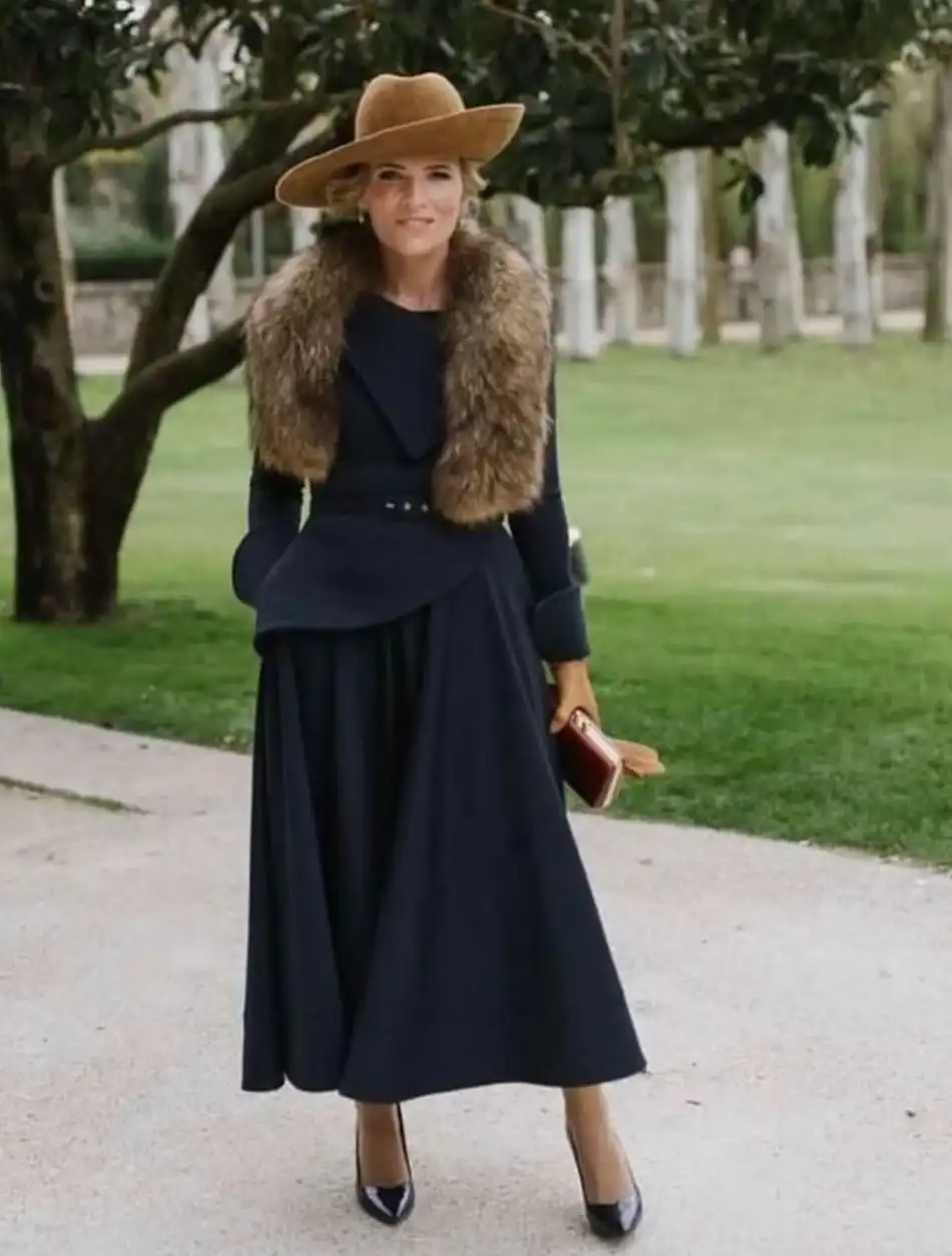 15 Winter Wedding Guest Outfits Over 40 That Handle the Cold 9 Navy Peplum Jacket and Full Midi Skirt With a Fur Collar