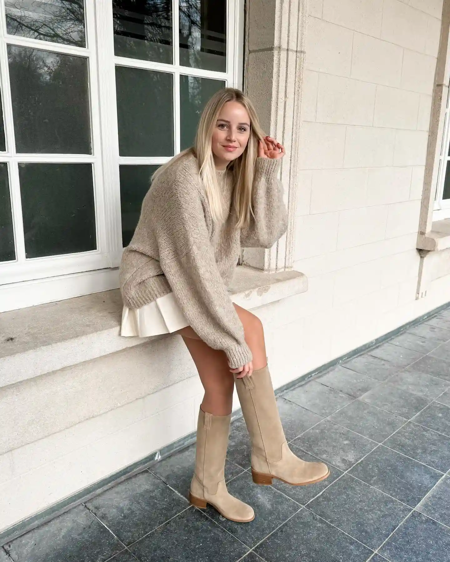 20 Ankle Boot Outfits for Women Over 40 3 2. Oversized Sweater with Tall Suede Boots