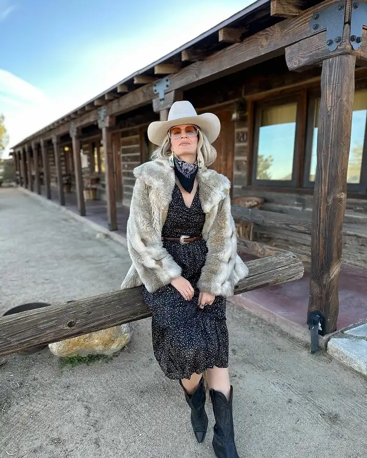 20 Classy Outfits for Women Over 40 10 Faux Fur Coat over a Floral Midi Dress with Cowboy Boots