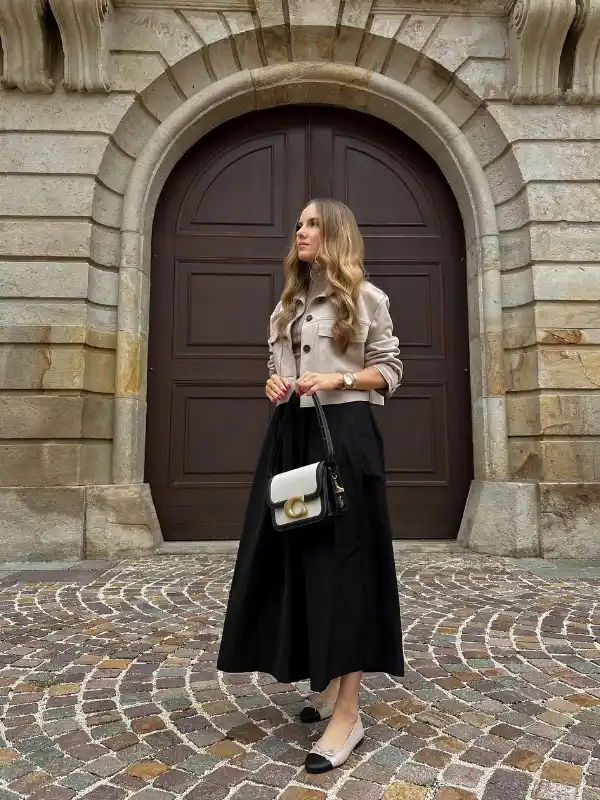 15 Fall Transitional Outfits for Women Over 40 (Summer-to-Fall) 7 6. Cropped Beige Jacket Over a Full Black Midi Skirt
