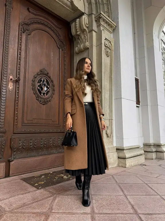 The Camel Coat Dressed Up Over a Pleated Skirt
