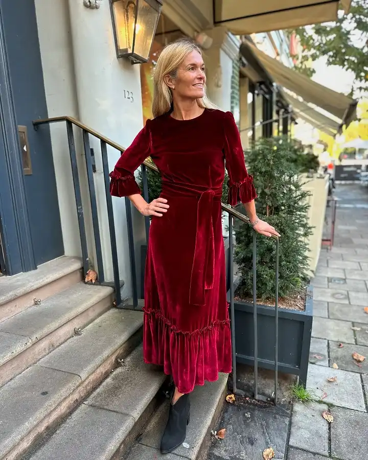 15 Winter Wedding Guest Outfits Over 40 That Handle the Cold 12 Red Velvet Midi Dress With Ruffle Cuffs