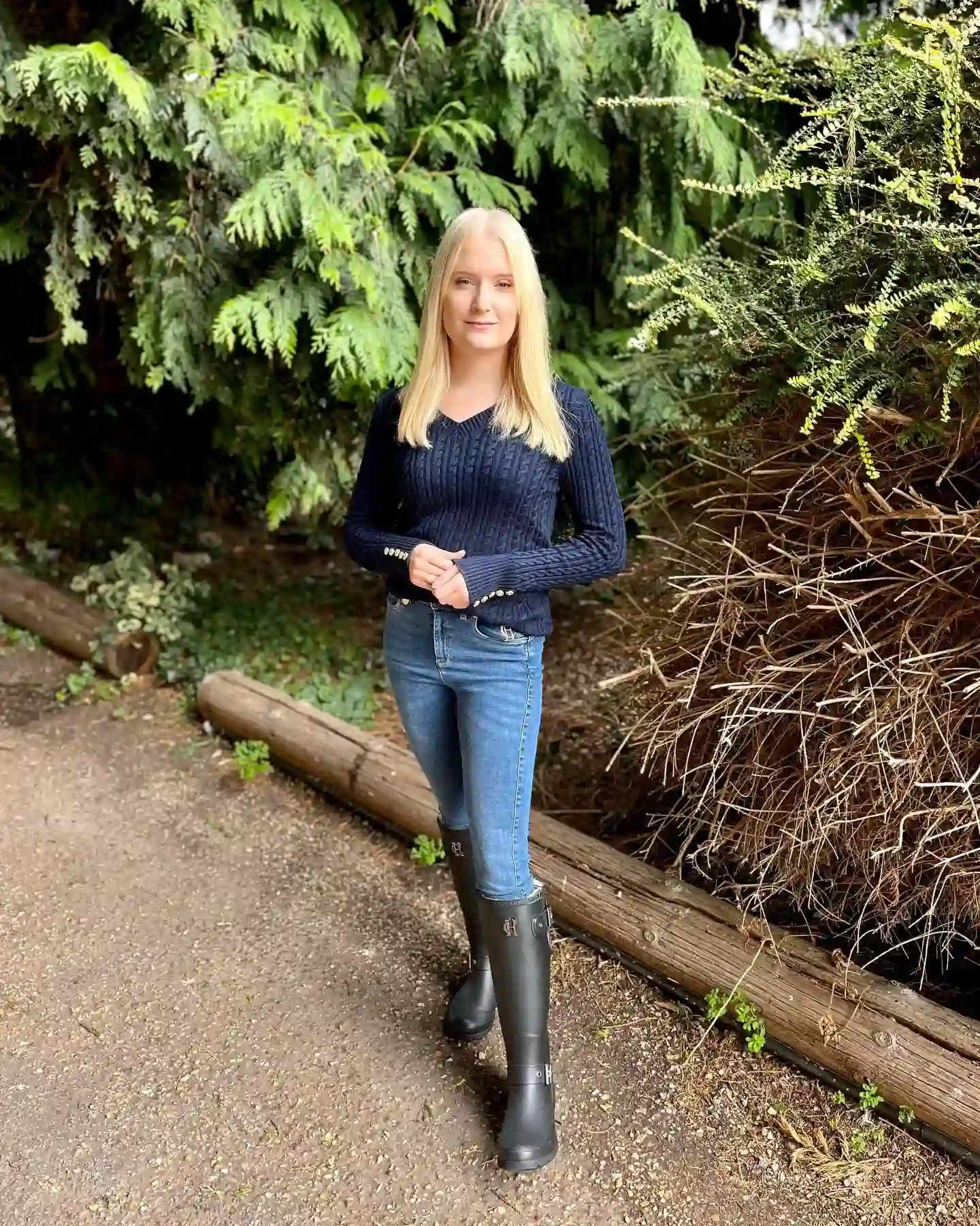 20 Ankle Boot Outfits for Women Over 40 8 7. Navy Sweater with Black Rain Boots