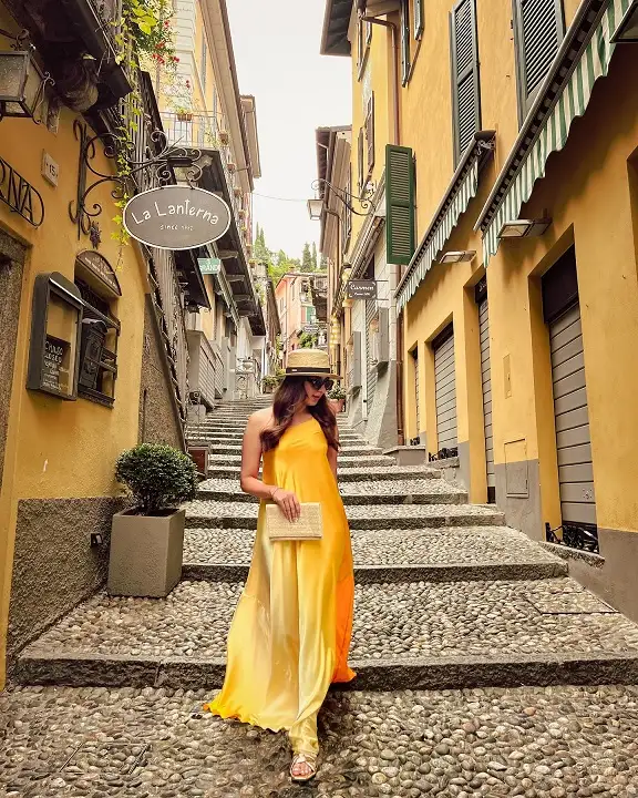 17 Italy Vacation Outfits for Women Over 40 That Look Effortlessly Chic 15 Marigold Satin One Shoulder Maxi Dress