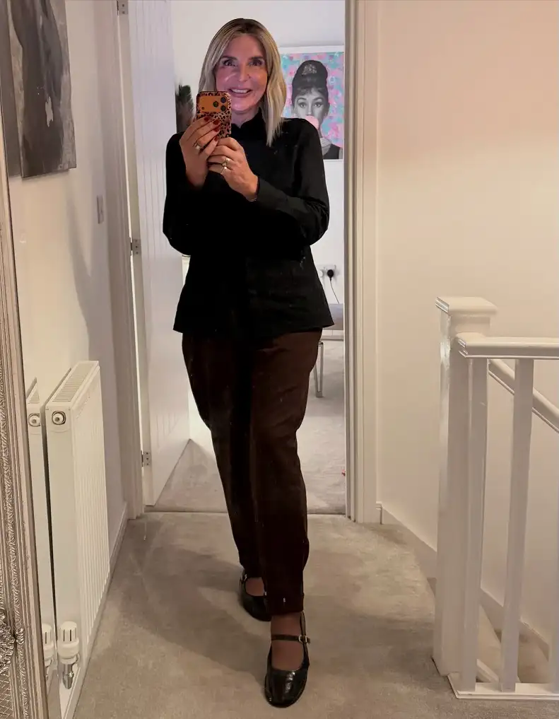 20 Work Outfits for Women Over 40 That Look Effortlessly Polished 17 Black Stand Collar Jacket with Brown Tapered Trousers