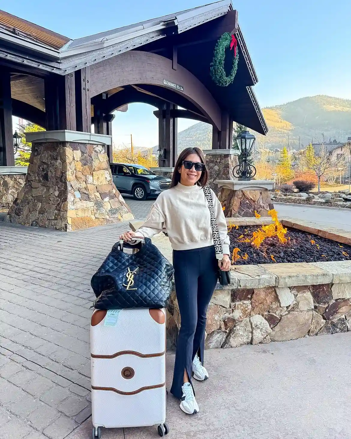 19 Winter Vacation Outfits Over 40 (Warm Getaways) 5 4. Cropped Sweatshirt and Flare Leggings for Travel Day