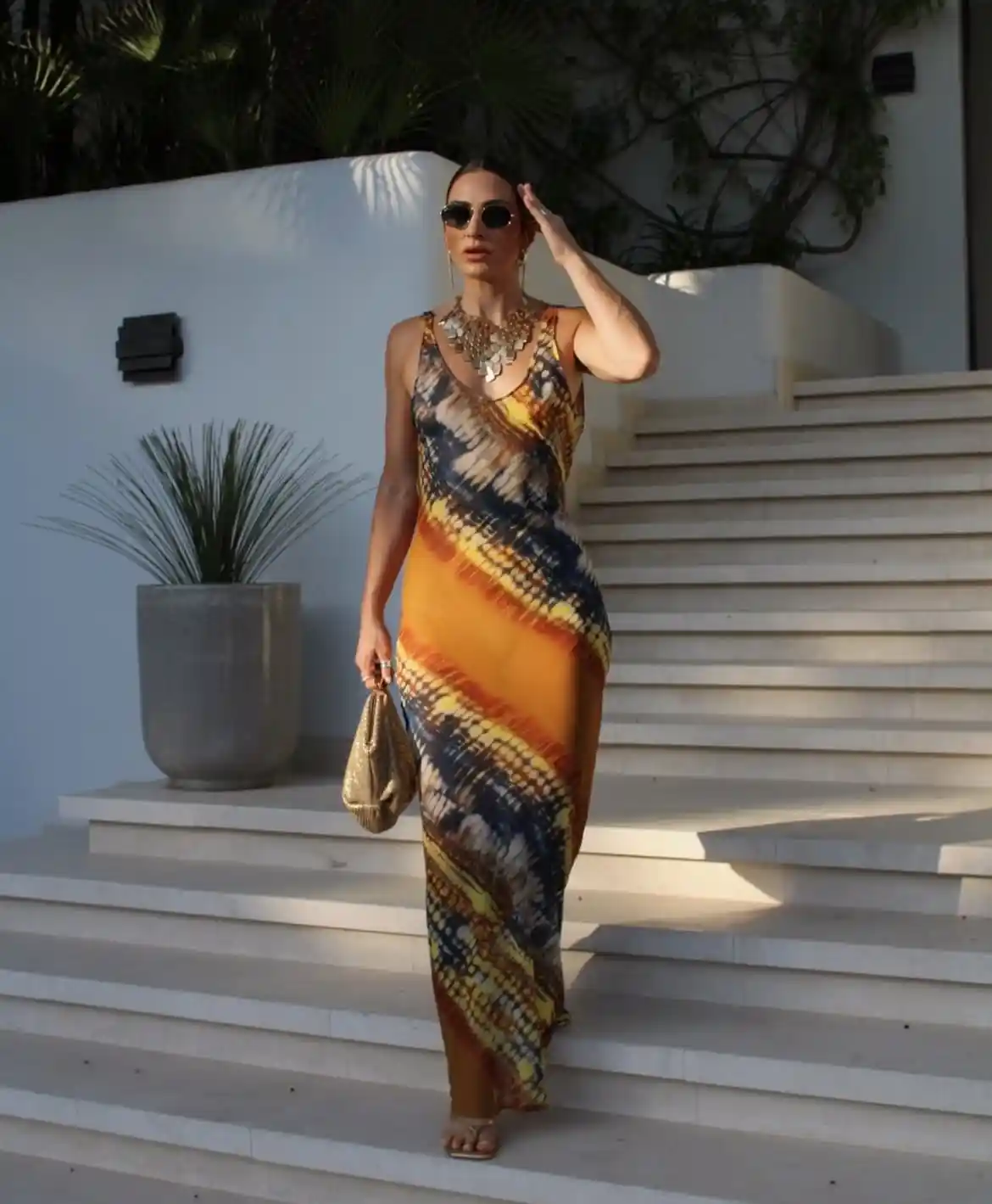 19 Holiday Outfits for Women Over 40 That Work for Parties, Dinners, and Sunny Trips 17 16. Sunset Print Slip Maxi for a Holiday Dinner Abroad