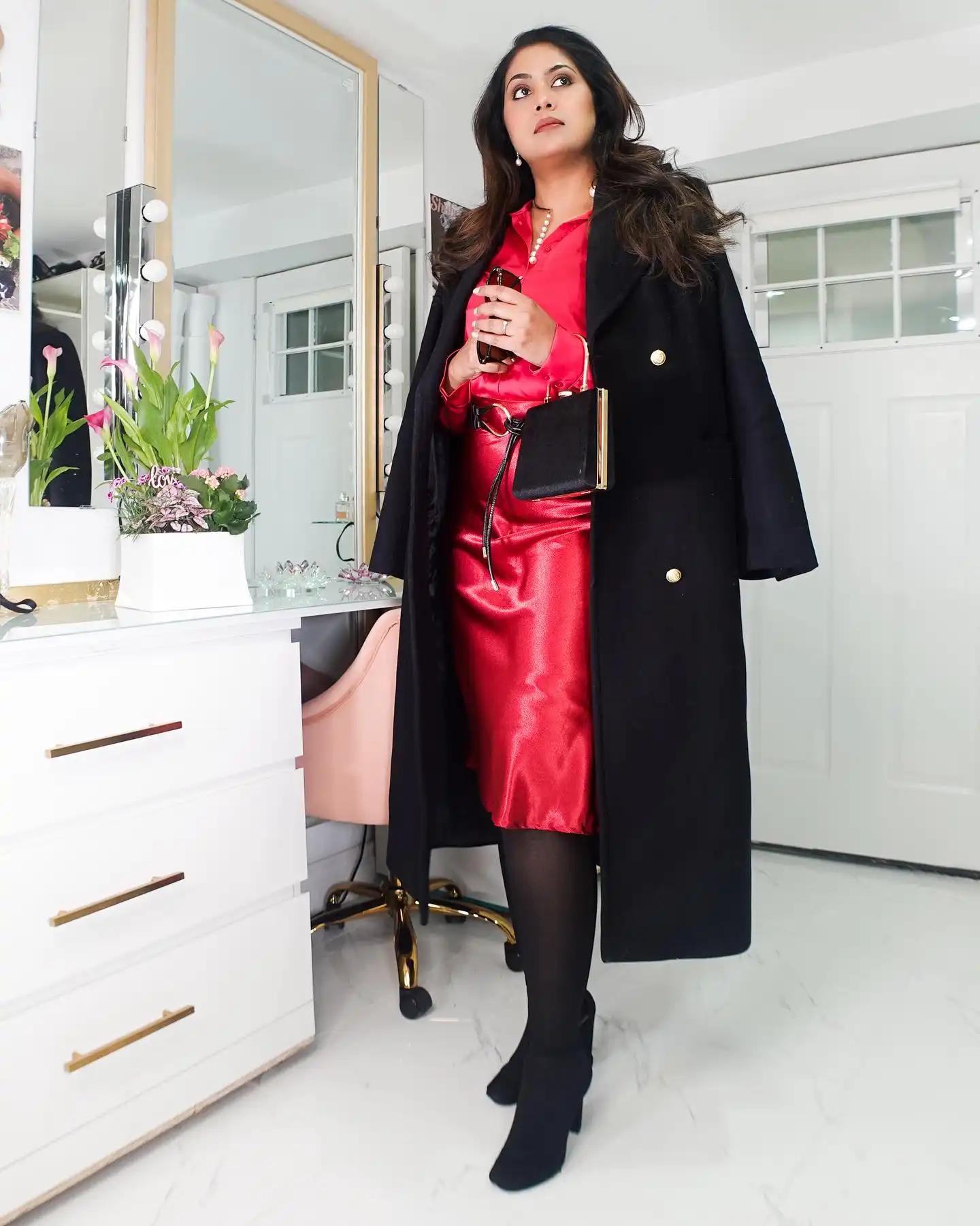 Red Satin Shirt and Skirt Under a Long Black Coat