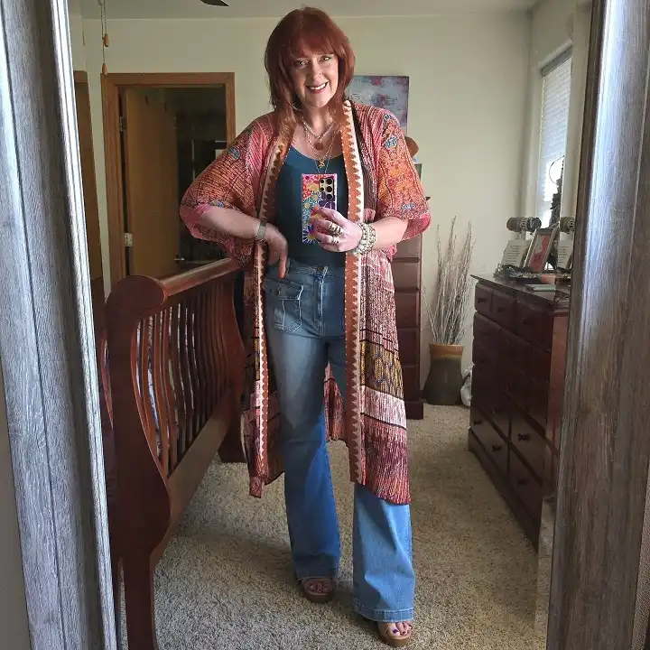 18 Boho Outfits for Women Over 40 (Not Costume-y) 11 Coral Kimono Duster over a Teal Tank and Flares