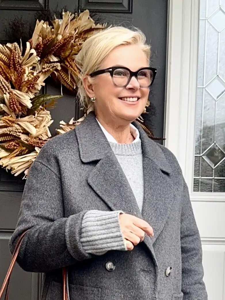 20 Chic Winter Outfits for Women Over 40 That Aren't Frumpy 17 Charcoal Coat With a Shirt and Sweater Layer