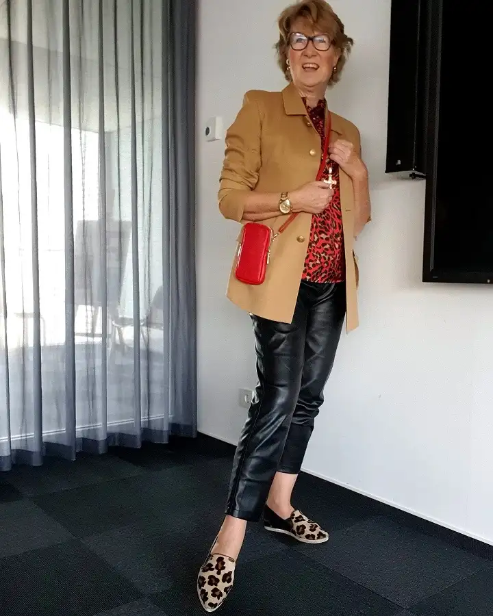 20 Work Outfits for Women Over 40 That Look Effortlessly Polished 9 Camel Jacket with a Red Leopard Blouse