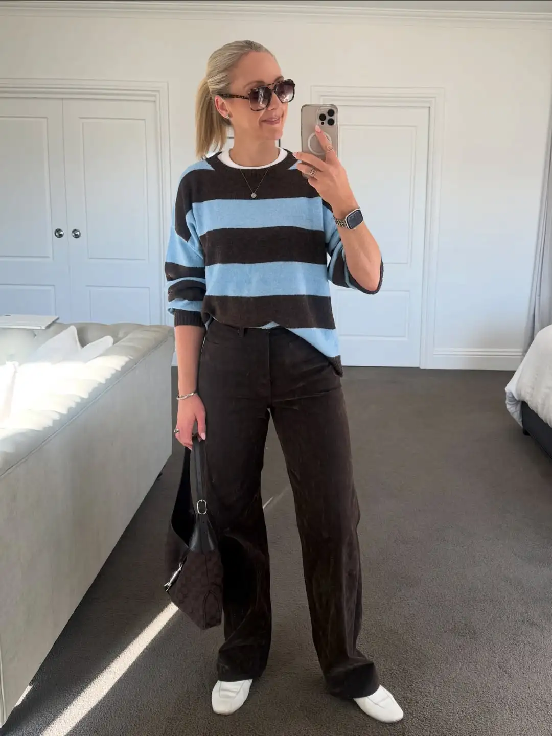 15 Chic Outfits for Women Over 40 You Can Copy This Week 8 Bold Striped Sweater With Chocolate Wide Leg Pants