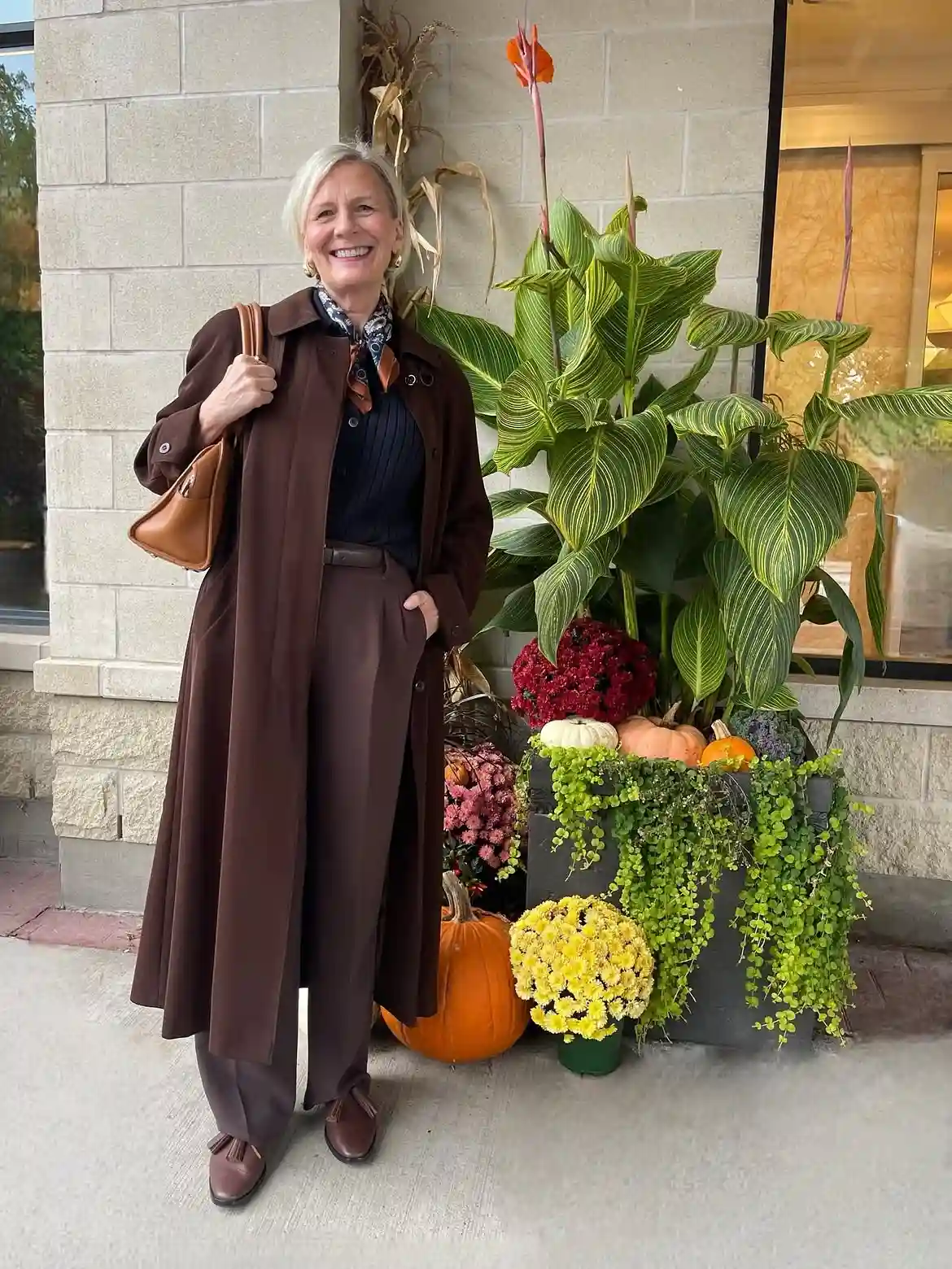 Modern Style: 20 Fall Outfits for Women Over 50 18 17. Long Coat with Pleated Trousers in Chocolate Tones