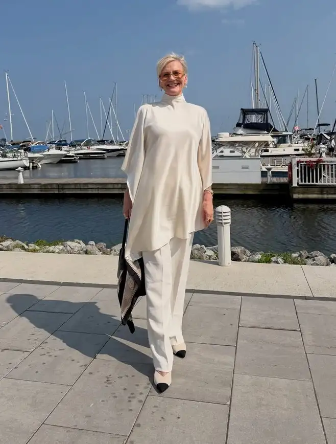 A Cream Satin Tunic Over Matching Wide Leg Trousers