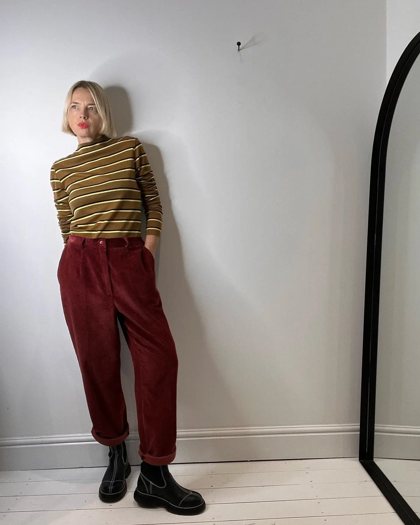 16 Corduroy Outfits for Women Over 40 9 8. Striped Top and Burgundy Corduroy Trousers