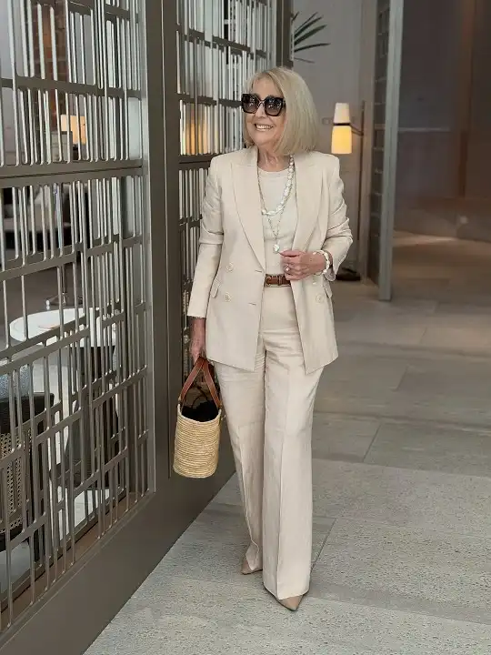 20 Classy Outfits for Women Over 40 9 Cream Linen Suit with Pearls
