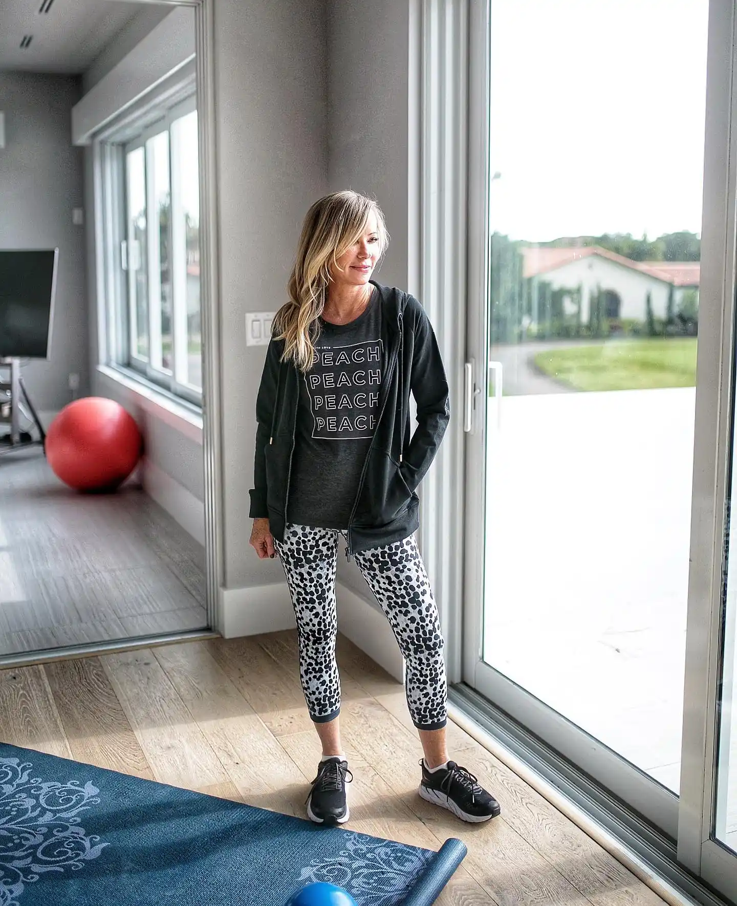 15 Athleisure Outfits for Women Over 40 2 1. Graphic Tee and Cropped Leggings