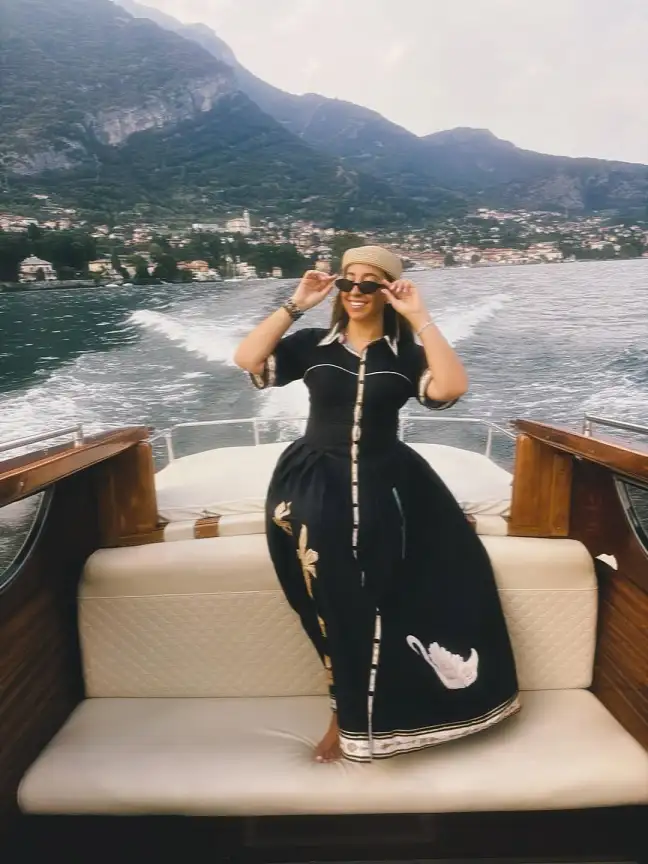 17 Italy Vacation Outfits for Women Over 40 That Look Effortlessly Chic 11 Black Shirt Dress with a Swan Print Skirt