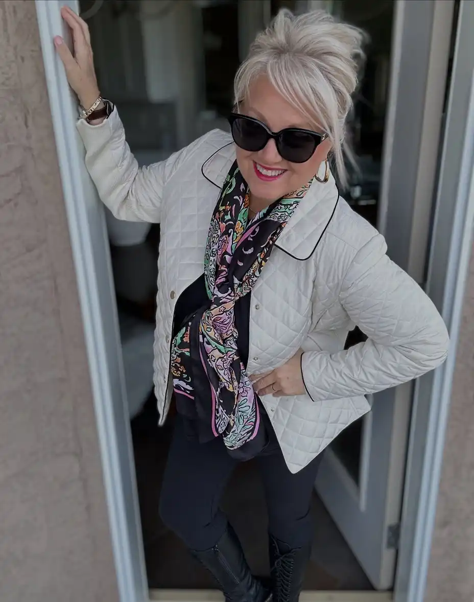 20 Classy Outfits for Women Over 40 11 Ivory Quilted Jacket with a Silk Scarf and Tall Boots