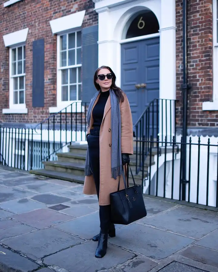 20 Chic Winter Outfits for Women Over 40 That Aren't Frumpy 7 Double Breasted Camel Coat With a Grey Scarf