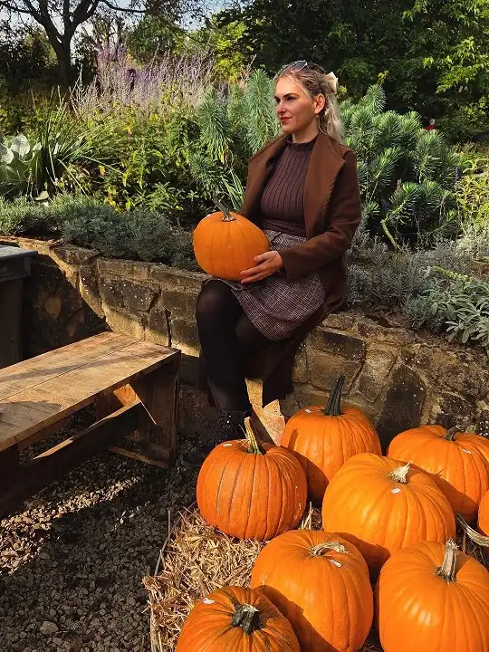 16 Pumpkin Patch Outfits Over 40 That Handle Mud, Hay, and Photos 5 Long Brown Coat Over a Ribbed Knit and Check Skirt
