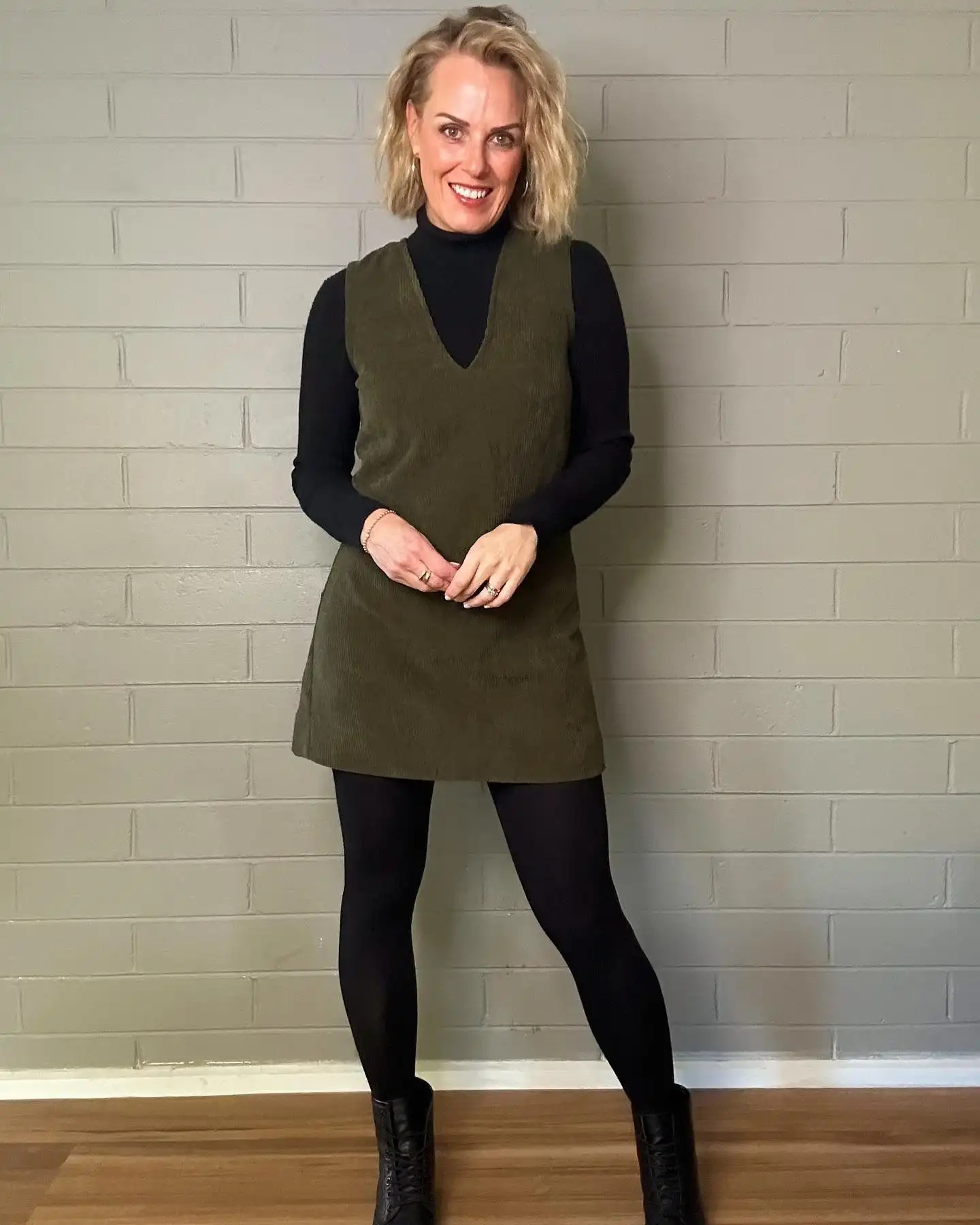 16 Corduroy Outfits for Women Over 40 16 15. Olive Corduroy Pinafore Dress and Black Turtleneck